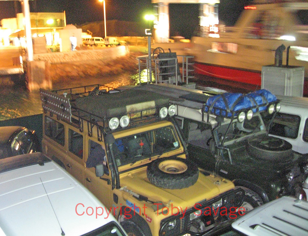 On the small ferry in southern Tunisia with Camel Kev in R157 CDU crossing to the island of Djerba. 2001.