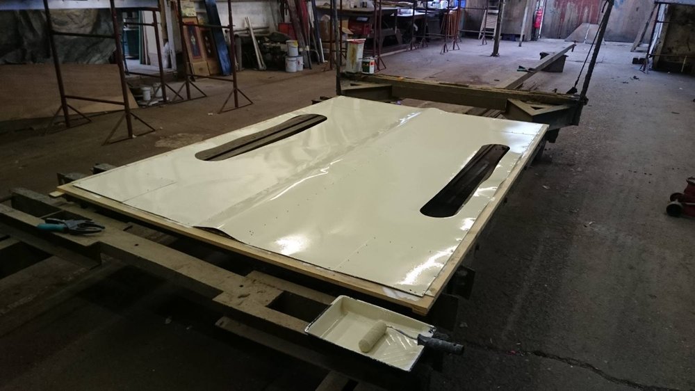 Roof secured to frame for top surface to be painted